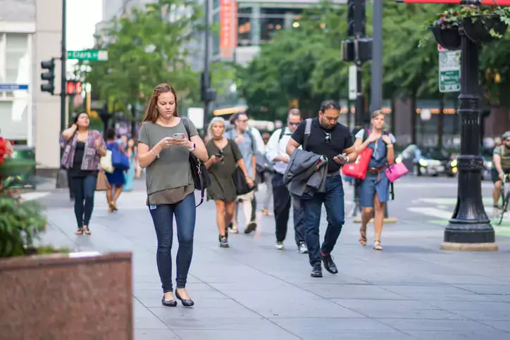 Young woman using her phone in the city